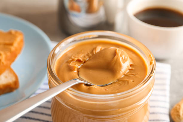 istock Yummy peanut butter breakfast on grey background, space for text and closeup 1154355557