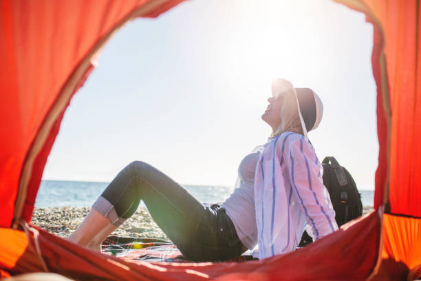 istock Woman watching sunset by the sea 1154356240