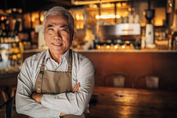 We want to give people a place to gather Senior man standing at small business cafe/restaurant/coffee shop. Active seniors concept taiwan people stock pictures, royalty-free photos & images
