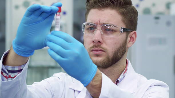istock Man looking at the test-tube at the laboratory 1154356949