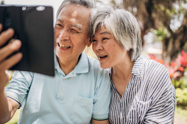 istock Beautiful senior couple using phone 1154358997