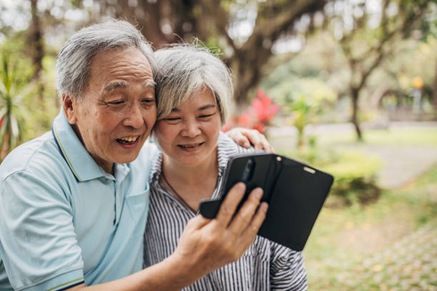 istock Beautiful senior couple using phone 1154359060