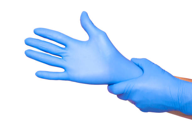 istock Hands wearing a blue latex glove, isolated on white background 1154361611
