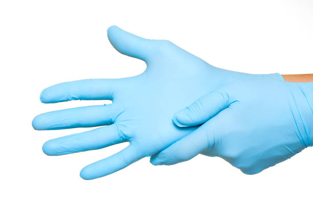 istock Doctor putting on protective blue gloves isolated on white background 1154361657