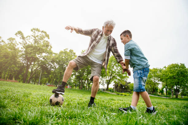 Time for soccer Time for soccer. Shadow DOF. Developed from RAW; retouched with special care and attention; Small amount of grain added for best final impression. 16 bit Adobe RGB color profile. old football stock pictures, royalty-free photos & images