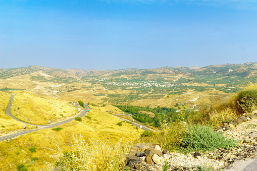 Landscape of the Golan Heights, winding road 98, and the Yarmouk River valley, near the border between Israel and Jordan