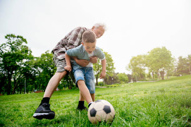 istock Grandfather and grandson enjoy a game 1154361930
