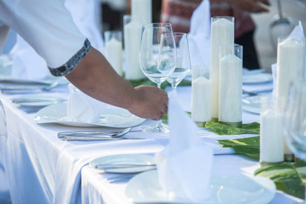 istock Waiter Setting and arranging Table At Restaurant for Wedding or Party 1154362480