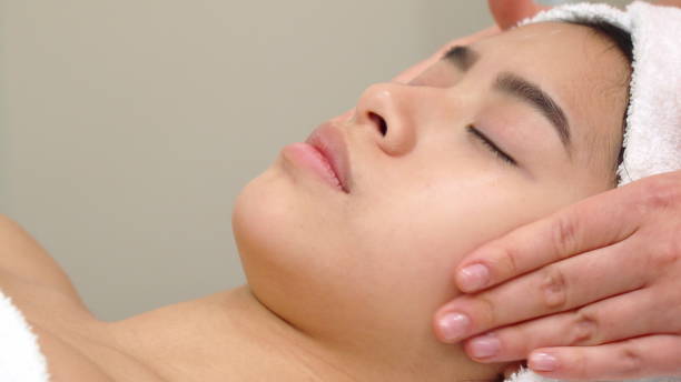 istock Massage specialist stokes girl's forehead 1154365872