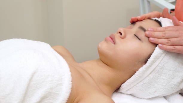 istock Masseur massagges girl's face 1154365887