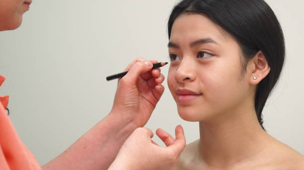 istock Beauty specialist uses cosmetic pencil 1154365941