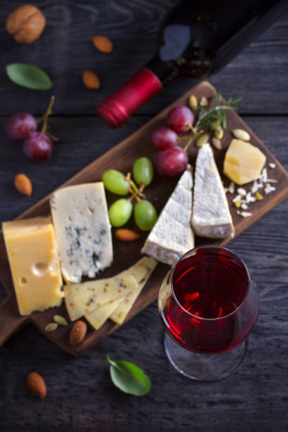 istock Red wine with cheese on chopping board. Wine and food concept 1154367317