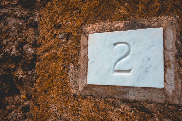 istock the number 2 on white stone with brown facade 1154368048