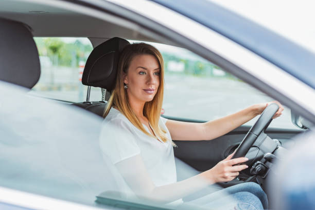 istock Businesswoman driving a car 1154370005