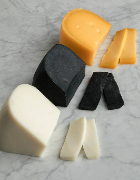 istock Piece of white goat cheese, black lemon cheese and Gouda cheese 1154370037