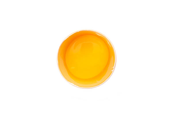 istock Half broken egg with yolk isolated on white background, top view 1154370985