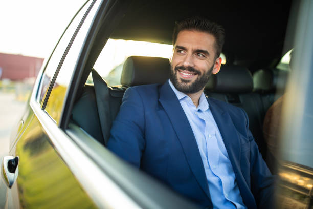 istock Handsome gentleman riding in a car 1154373308