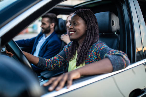 istock African woman driving handsome in a car 1154373348