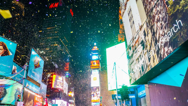 New York City, USA, December 31, 2014, Extreme party atmosphere on street intersection of times square on new year's eve midnight after ball drop when confetti flies all over the place stock photo
