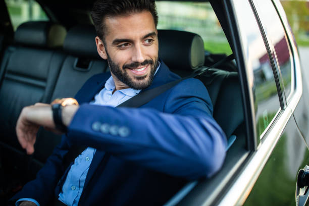 istock Handsome gentleman riding in a car 1154373366