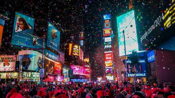 new york city, usa, january 1, 2015, atmospheric new year's eve celebration on famous times square intersection after midnight with countless happy people enjoying the party - new york city times square crowd people imagens e fotografias de stock