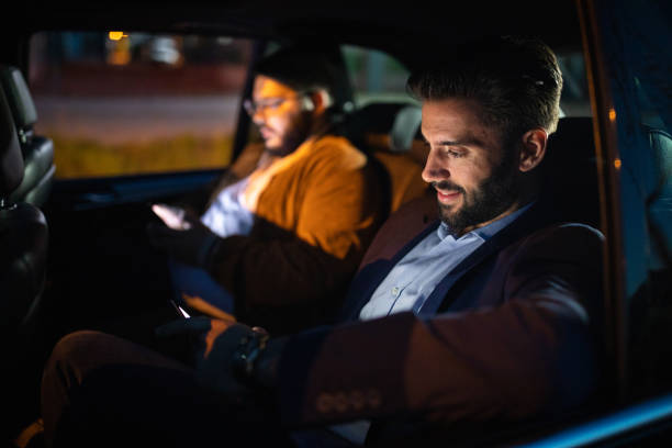 istock Male friend in car driving at night 1154373464