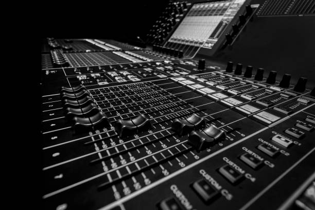 istock Wide angle closeup of Professional Audio Digital Sound Mixing Control Console. Silver White Faders and black Graphic control Console 1154373513