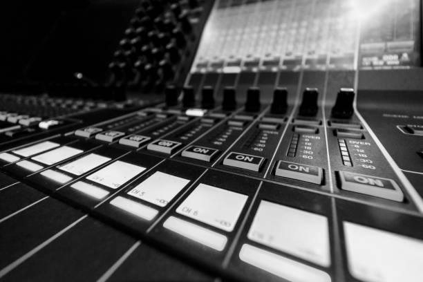 istock Wide angle closeup of Professional Audio Digital Sound Mixing Control Console. Silver White Faders and black Graphic control Console 1154373515