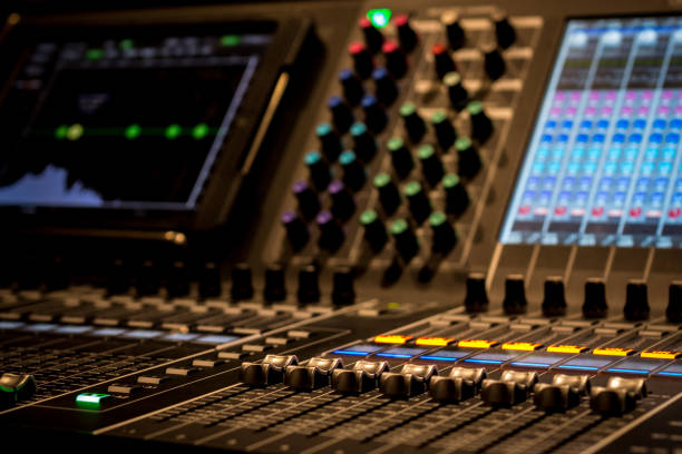 istock closeup of Professional Digital Audio Sound Mixing Control Console. Silver White Faders and black Graphic control Console, touchscreen control and digital encoders 1154373576