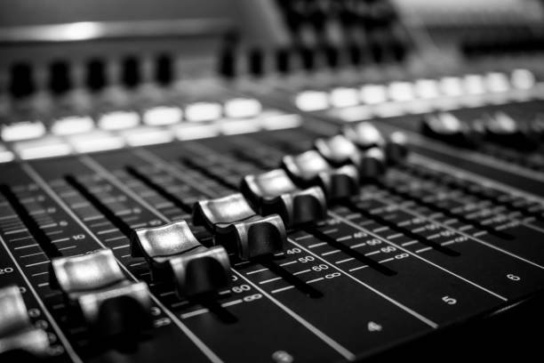 istock Wide angle closeup of Pro Audio Digital Mixing Console. White Faders and black control Console 1154373594
