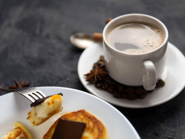 istock white Cup of espresso and cheese pancakes with bitter chocolate 1154375871