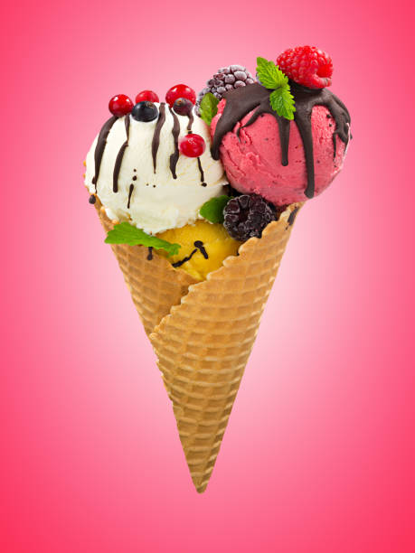 istock Waffle cone with three different scoops of ice cream decorated with berries, mint and topping on pink background 1154377447