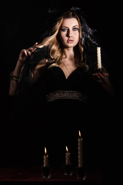 istock Mysterious young woman with a candle 1154378529