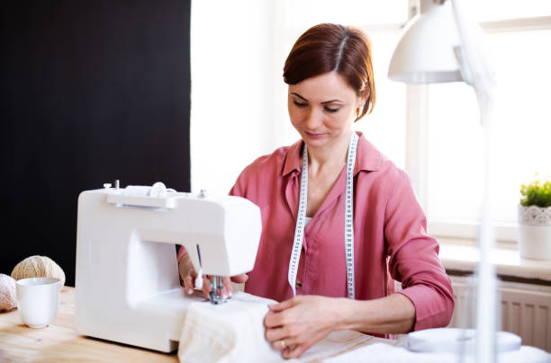 istock Young creative woman in a studio, working. A startup of tailoring business. 1154381666