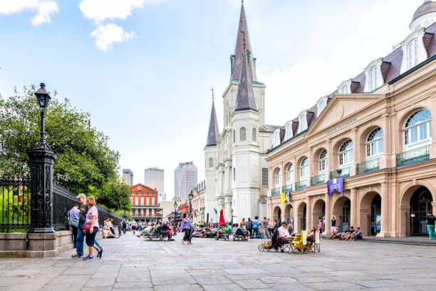 Old town chartres street in Louisiana famous city with many people crowd on Jackson square and church New Orleans, USA - April 22, 2018: Old town chartres street in Louisiana famous city with many people crowd on Jackson square and church jackson square stock pictures, royalty-free photos & images