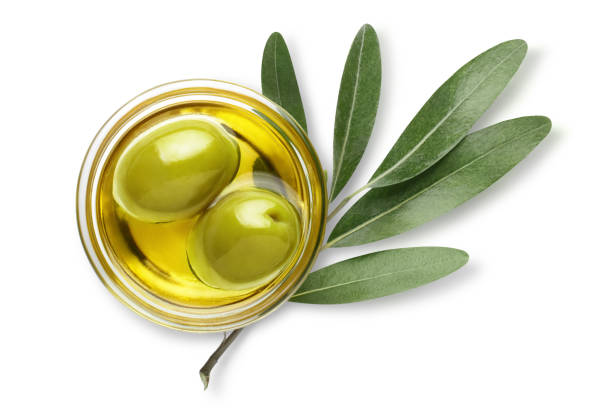 Olives on white Delicious big green olives in an olive oil with leaves, isolated on white background, view from above olive tree cut out stock pictures, royalty-free photos & images
