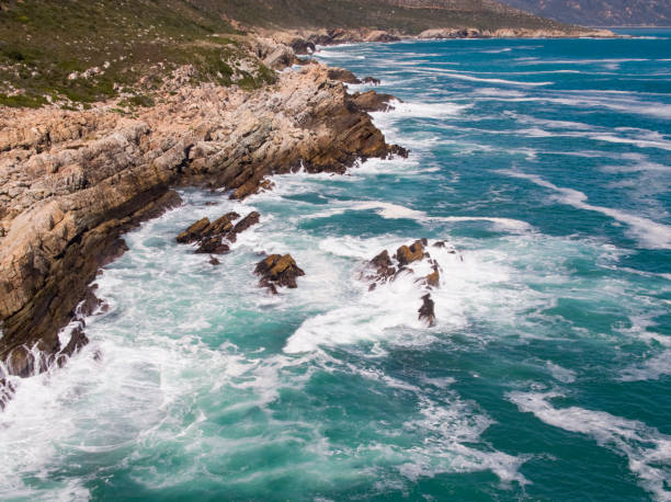 istock Sea waves crashing against a rocky shore 1154384044