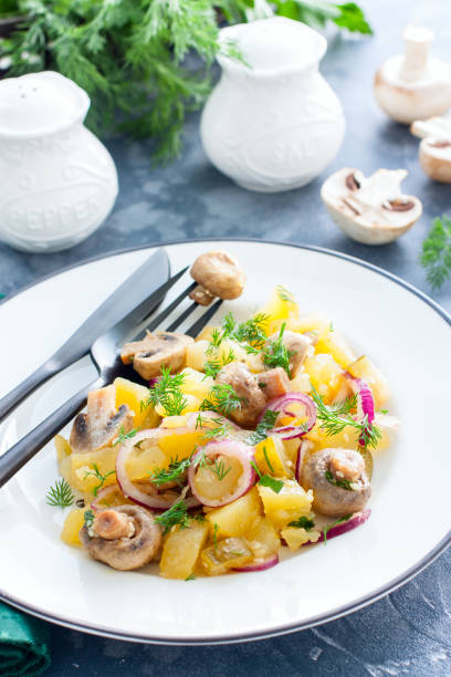 istock Potato salad with marinated champignons on a white plate, selective focus 1154384143