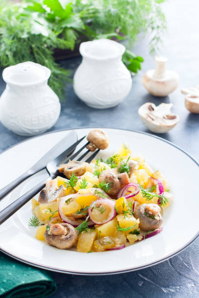 istock Potato salad with marinated champignons on a white plate, selective focus 1154384161