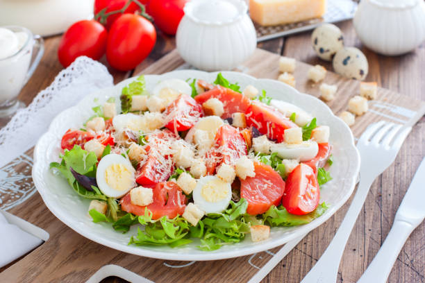 istock Caesar salad with red fish on the wooden table, horizontal 1154384430
