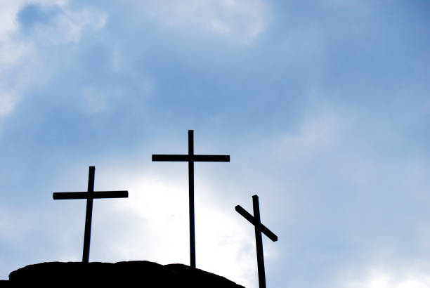 istock Three black Christian crosses with the cloudy sky 1154386402