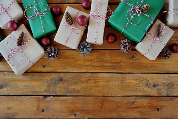 istock Christmas presents laid on a wooden table background 1154386430