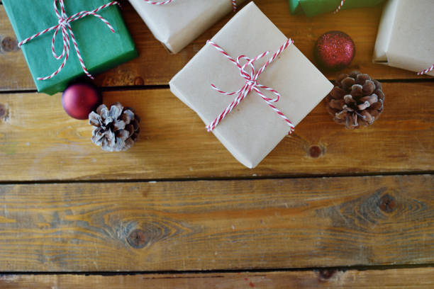 istock Christmas presents laid on a wooden table background 1154386452