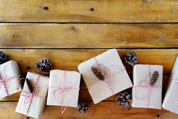 istock Christmas presents laid on a wooden table background 1154386458