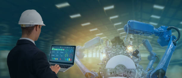 istock iot industry 4.0 concept,industrial engineer using software (augmented, virtual reality) in tablet to monitoring machine in real time.Smart factory use Automation robot arm in automotive manufacturing 1154387323