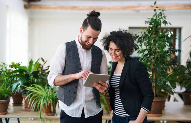 istock Two young businesspeople using tablet in office, start-up concept. 1154388534