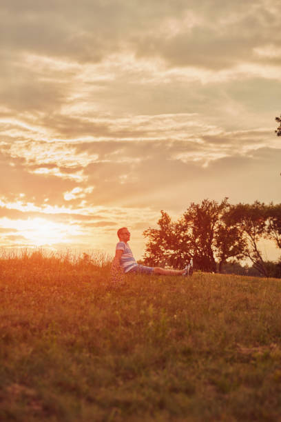 istock Man enjoying sunset/sunrise in nature. 1154391983