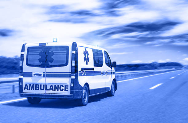 Ambulance van on highway with flashing lights stock photo