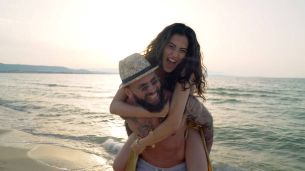 istock Young couple having fun on the beach 1154394123