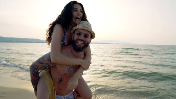 istock Young couple having fun on the beach 1154394189